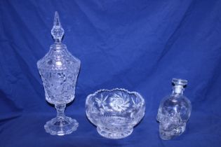 A box of assorted vintage glassware including a skull decanter