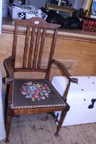 A vintage open armed wooden chair with embroidered seat, shipping unavailable