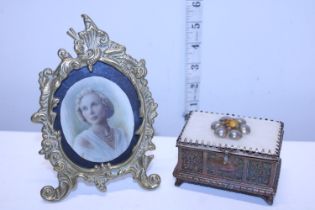 A vintage brass jewellery casket and a brass photo frame with miniature