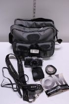 A vintage Olympus OM-10 camera and accessories