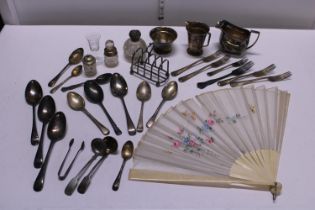 A box full of assorted flatware, silver plate and other including some silver and an antique fan