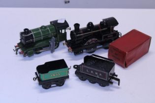 A selection of tin plate model trains and a Hornby clockwork locomotive working