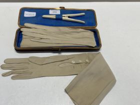 A boxed pair of vintage leather gloves along with glove stretchers