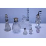 A selection of assorted silver topped perfume bottles and other glass bottles