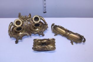 A antique brass desktop set including double ink well, blotter and pen tray