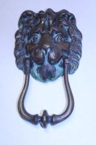 A heavy bronze lion form door knocker