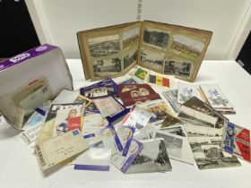 A vintage album of real photographs with a selection of stamps and silks etc