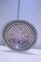 A hand painted porcelain plate in a white metal surround overall diameter 40cm