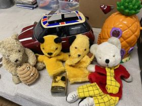 A box full of assorted toys including Sooty & Sweep puppets etc