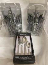 Three boxes of new cutlery