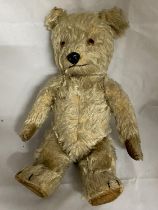 A vintage child's articulated bear