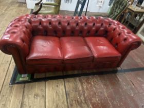 A vintage Chesterfield three seater sofa in Ox Blood red (needs one new castor), shipping