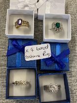 Four boxed costume jewellery rings