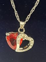 A 925 silver chain with double red stone heart pendant