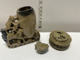 A selection of soap stone ornaments including brush pot