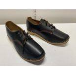 A pair of handmade wooden soled shoes