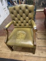 A vintage Chesterfield style leather arm chair, shipping unavailable