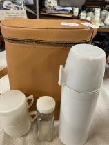 A vintage cased Thermos picnic set
