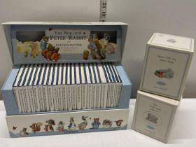 A box set of Beatrix Potter Peter Rabbit books and two Carte Blance boxed water globes