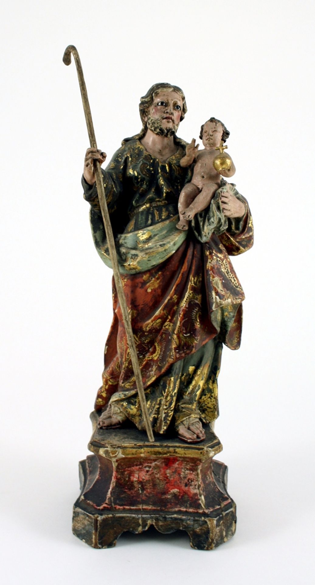 Hl. Josef mit dem Jesuskind. Ornamental staffiertes Gewand. Glasaugen. Holz gefasst und vergoldet.