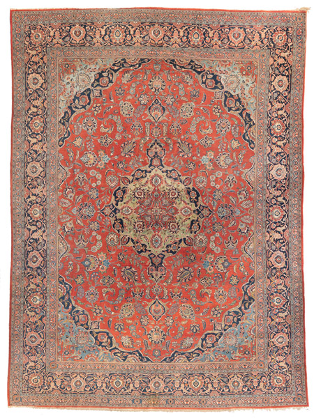 A decorative Kashan carpet with light green medallion