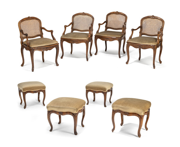 A SET OF FOUR SOUTHGERMAN BAROQUE CARVED WALNUT FAUTEUILS AND A SET OF FOUR STOOLS