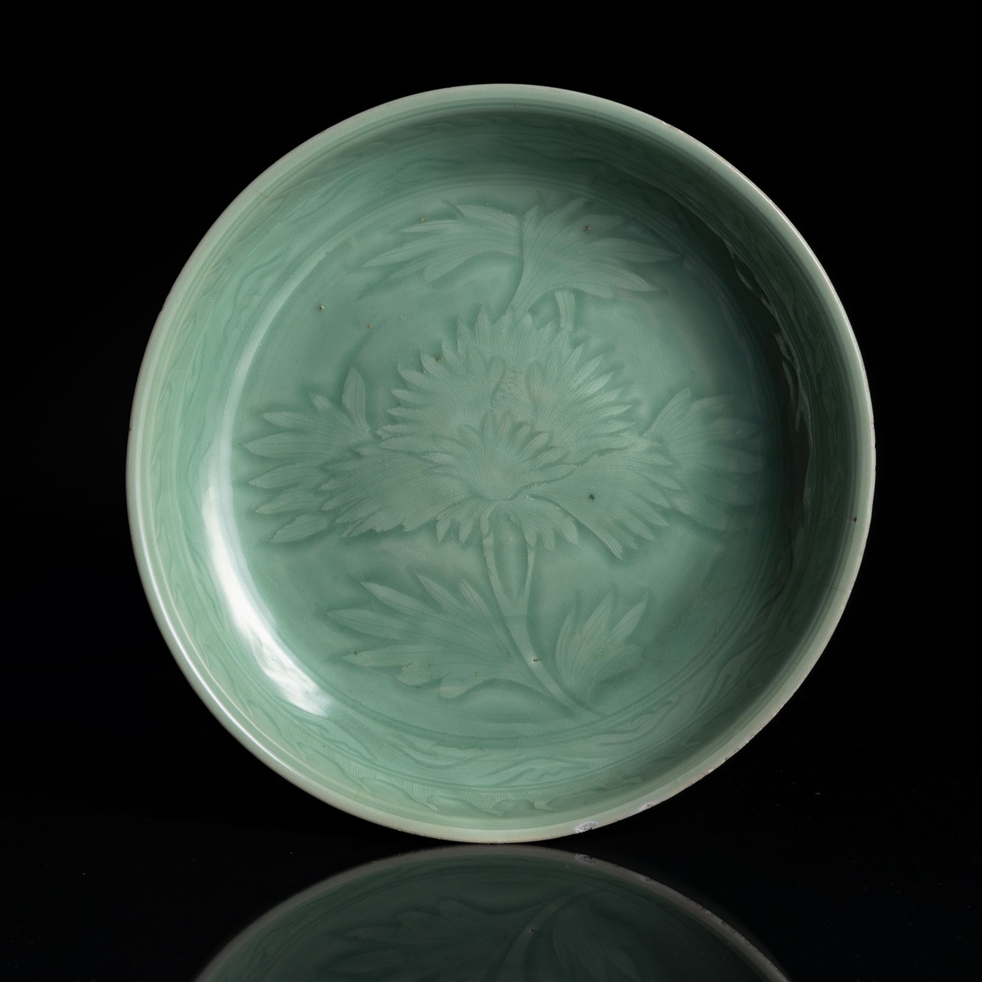 A RARE DEEP CELADON BOWL WITH A SINGLE PEONY BLOSSOM