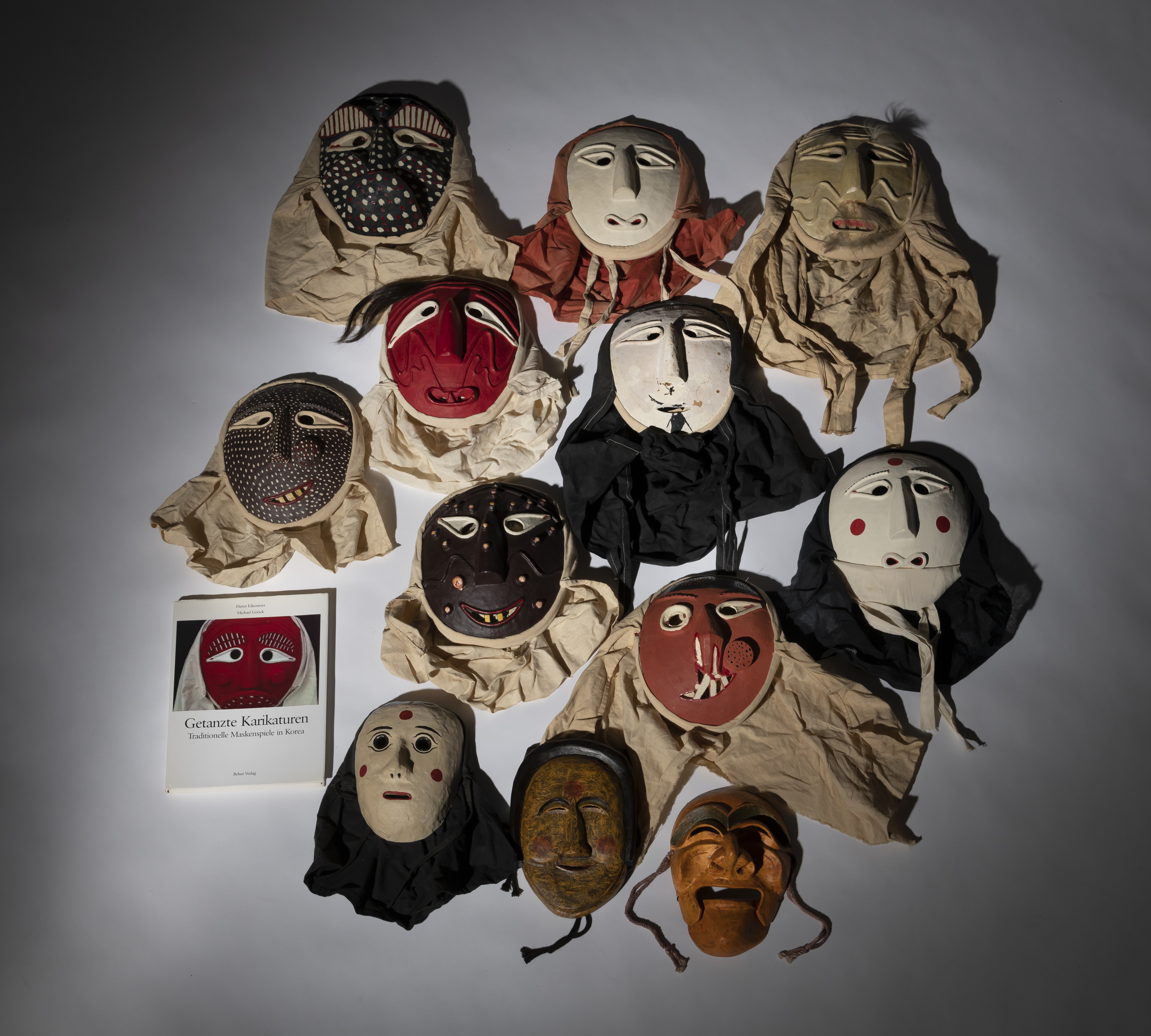 A GROUP OF TWELVE TRADITIOINAL MASKS AND THE BOOK "DANCED CARICATURES" BY DIETER EIKEMEIER - Image 2 of 4