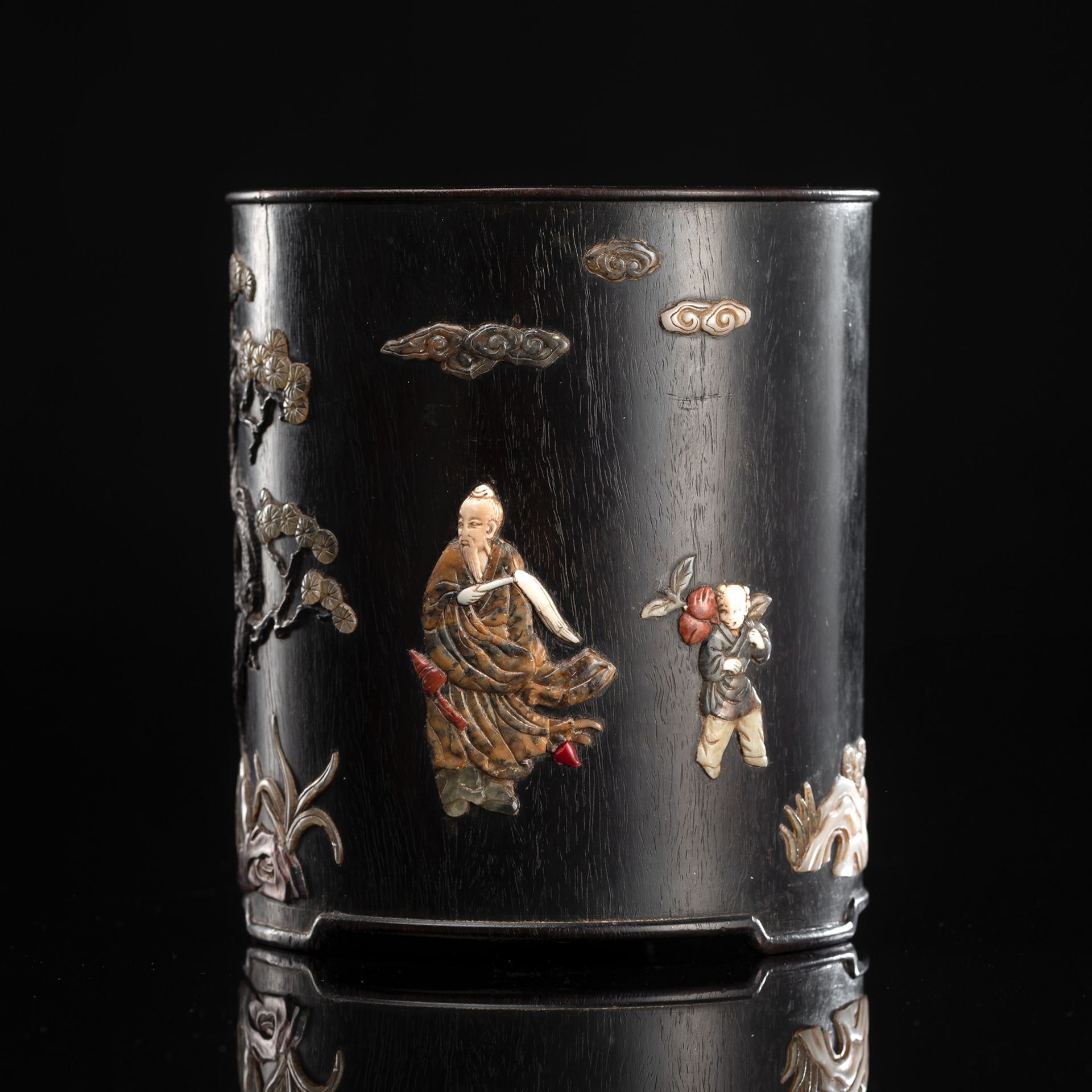 A CYLINDRICAL WOOD BRUSHPOT WITH DECORATED SCHOLAR NEAR PAGEBOY AND PINE