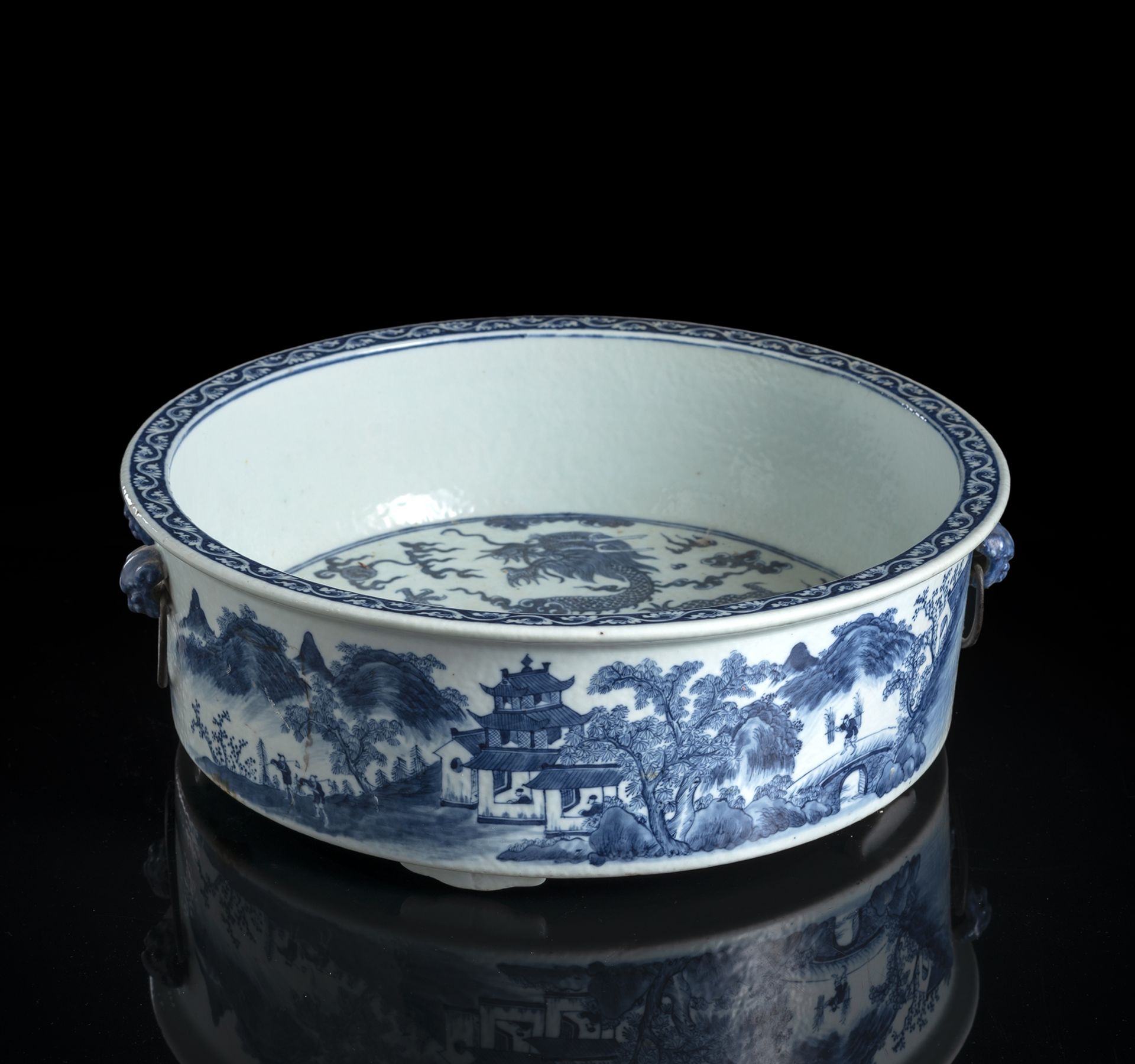 A BLUE AND WHITE DRAGON AND LANDSCAPE DEEP FOOTED BOWL