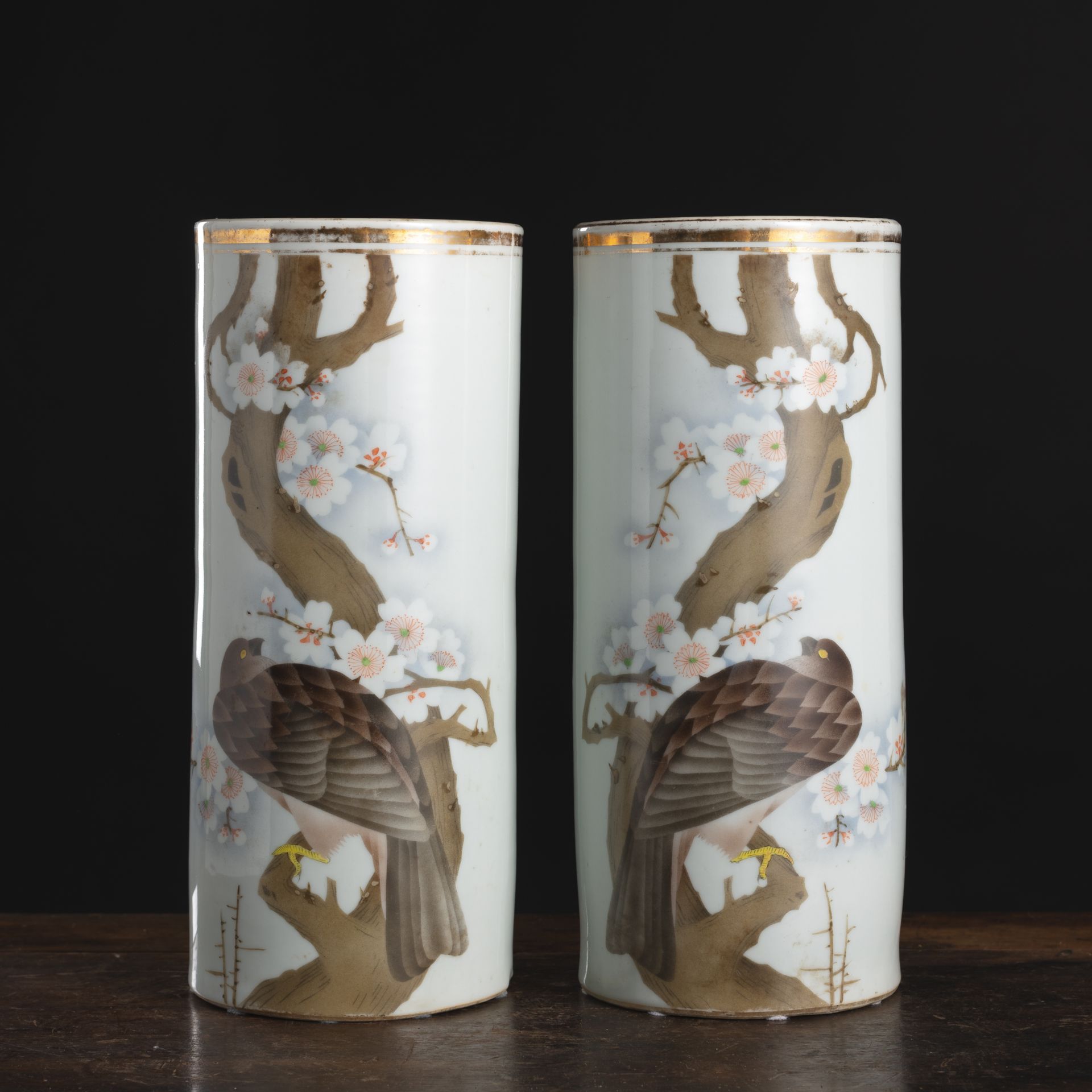 A PAIR OF CYLINDRICAL POLYCHROME BIRD OF PREY ON BRANCHES PORCELAIN VASES