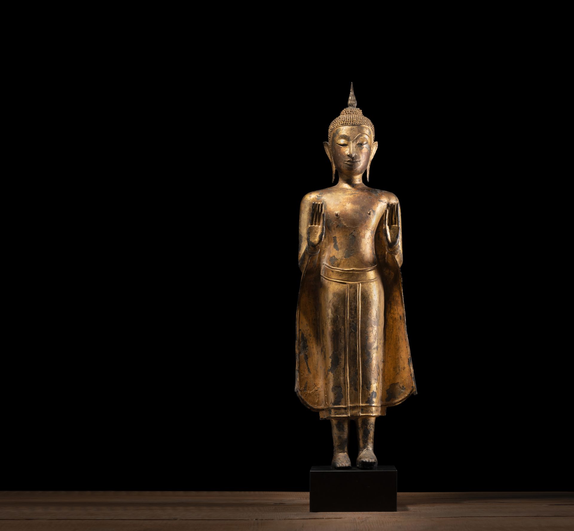 A GILT- AND BLACK-LACQUERED BRONZE FIGURE OF BUDDHA SHAKYAMUNI