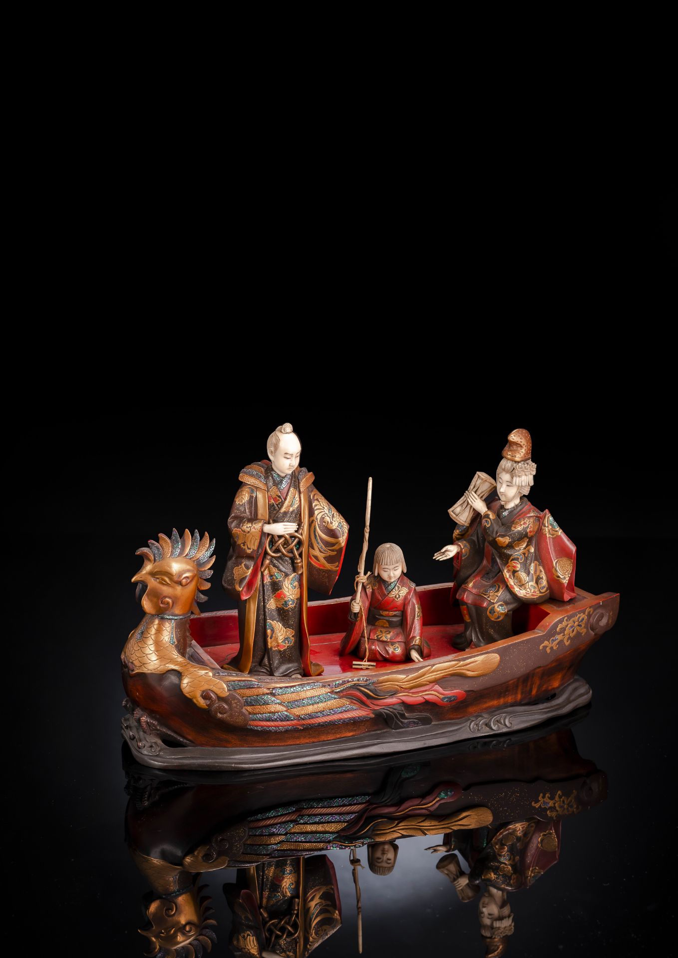 A LACQUERED WOOD OKIMONO OF A BOAT WITH THREE PASSENGERS