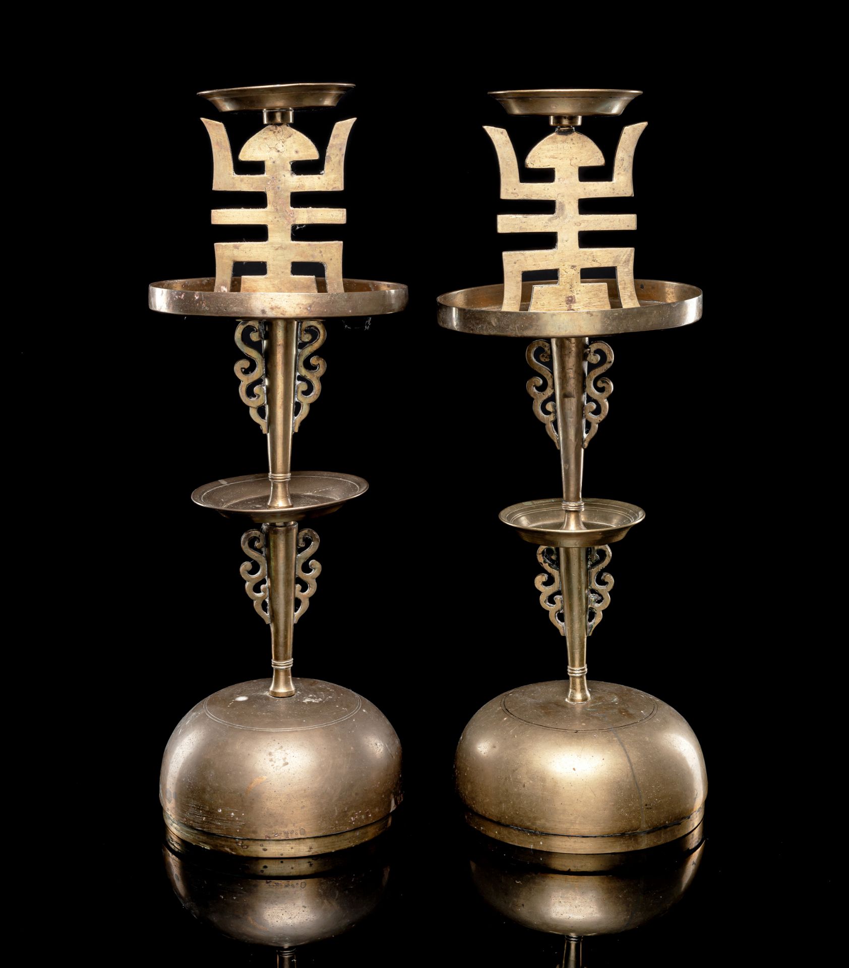 A PAIR OF BRASS CANDLE HOLDERS