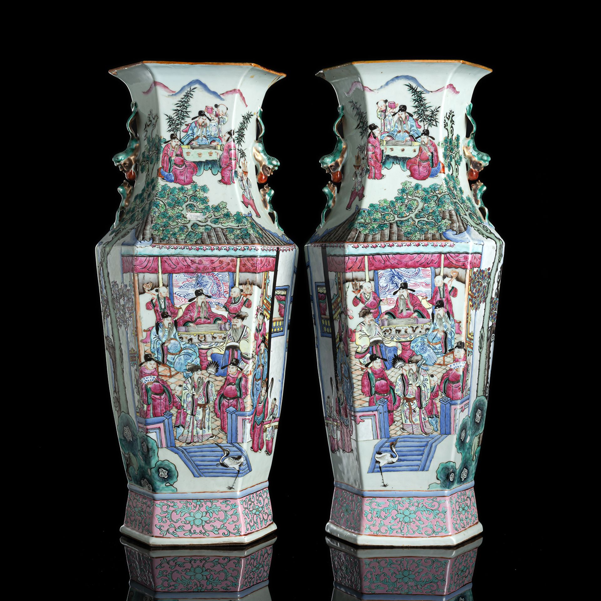 A PAIR OF HEXAGONAL 'FAMILLE ROSE' FIGURAL PORCELAIN VASES WITH FO-LION-HANDLES