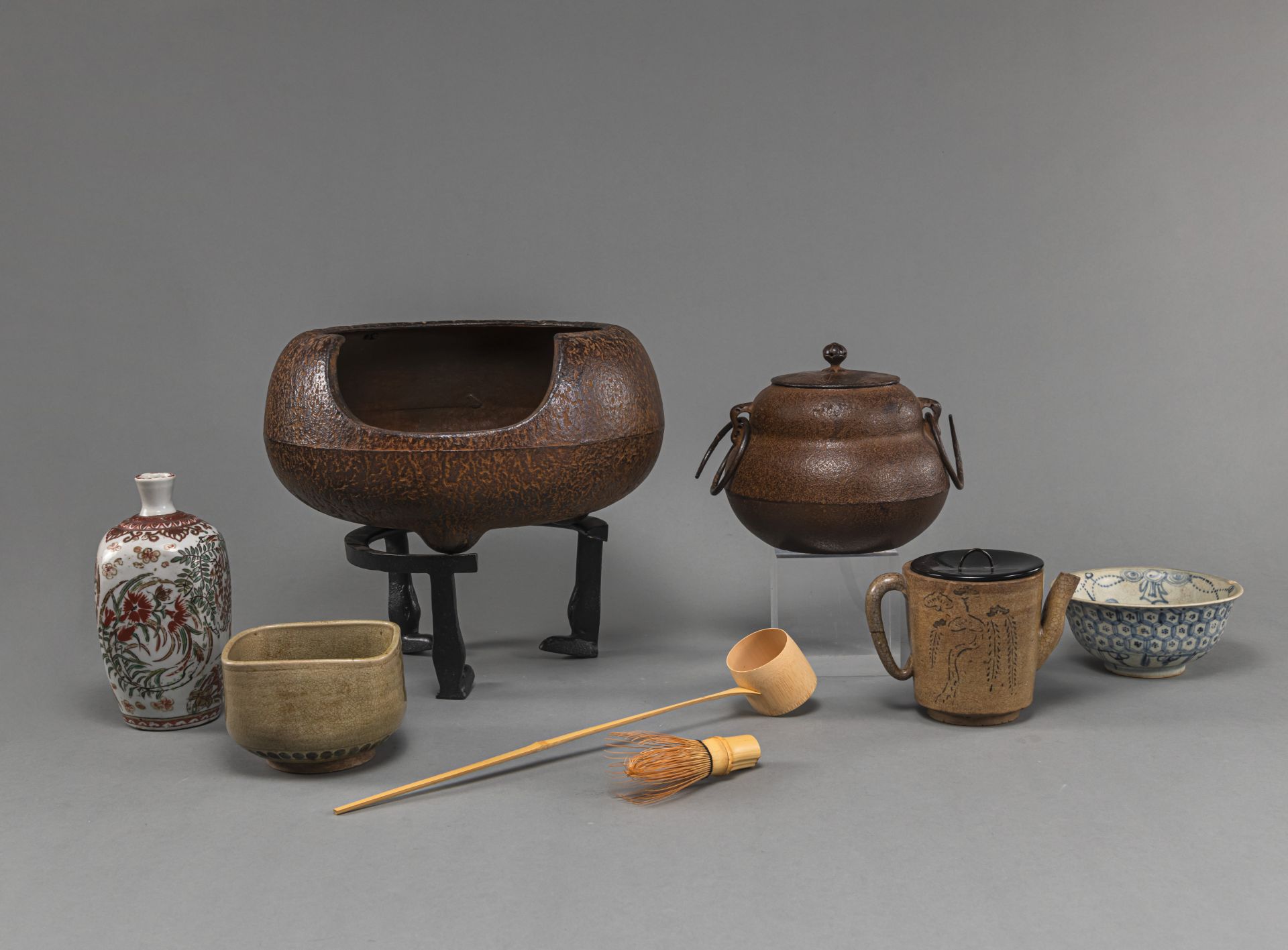 A GROUP OF TEA CEREMONY UTENESILS WITH IRON HIBACHI AND CHAGAMA, CHAWAN AND BOWL, BAMBOO SPOON AND 