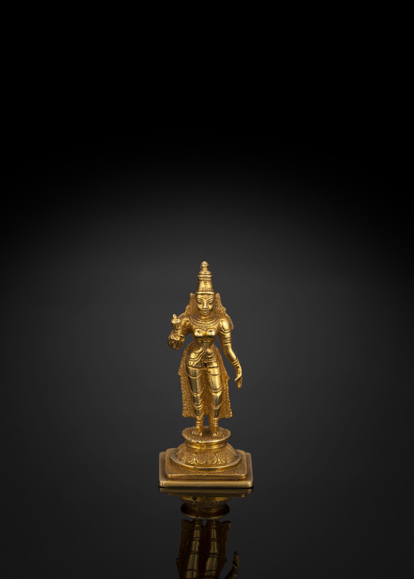 A GOLD FIGURINE OF SRI DEVI