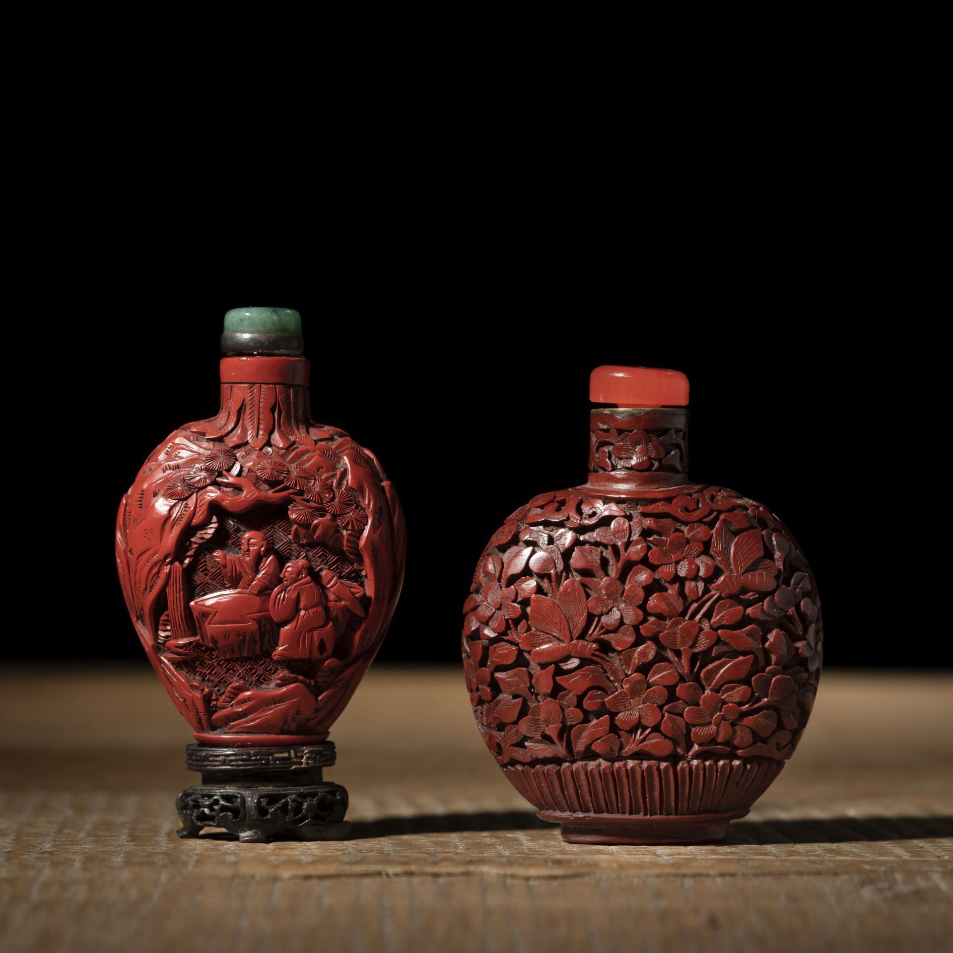 TWO RED LACQUER CARVED SNUFF BOTTLES DEPICTING FLOWERS, BIRDS AND SCHOLARS