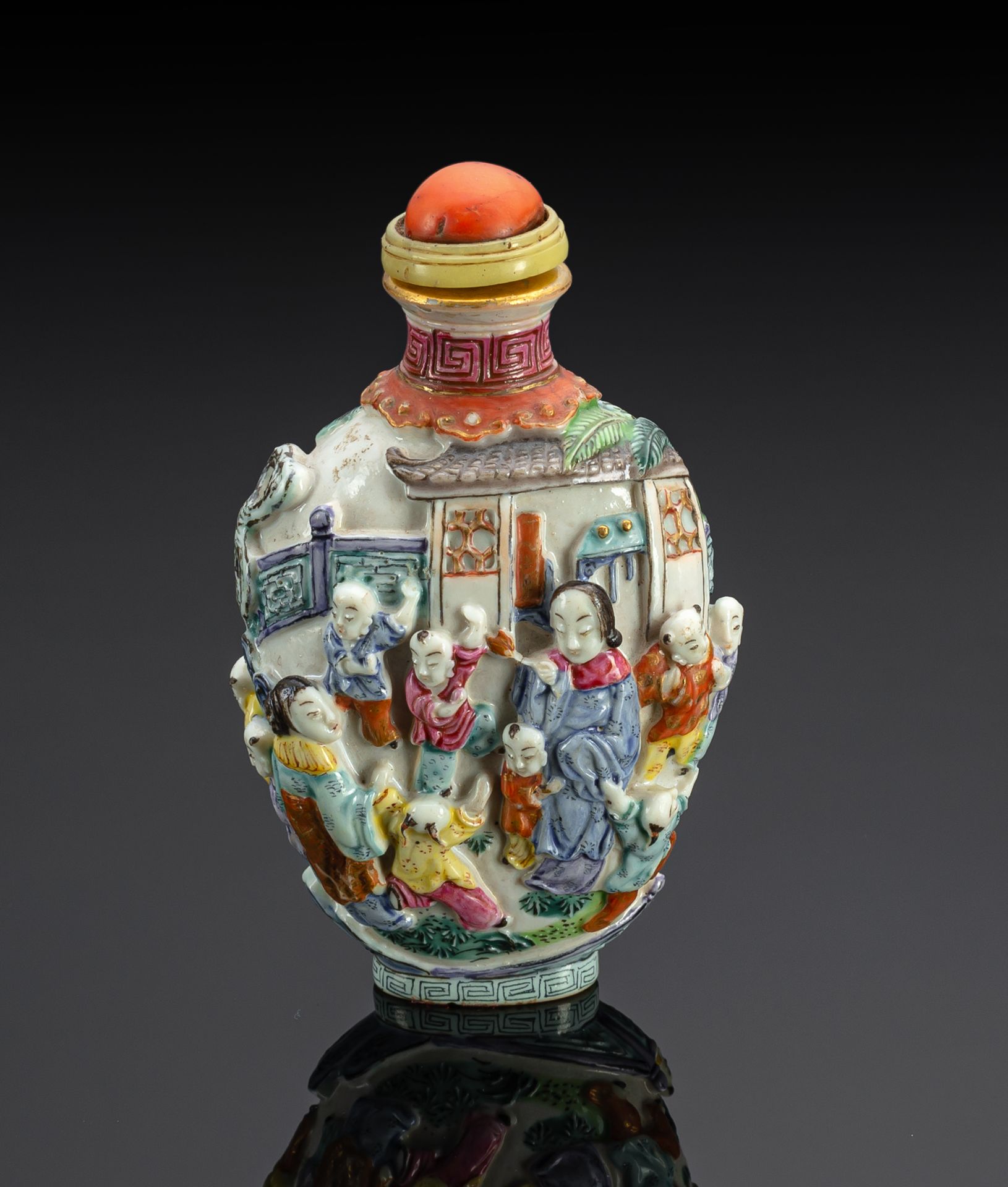 A MOLDED AND POLYCHROME PAINTED PORCELAIN SNUFFBOTTLE WITH THE 'FOUR LADIES AND SIXTEEN BOYS'