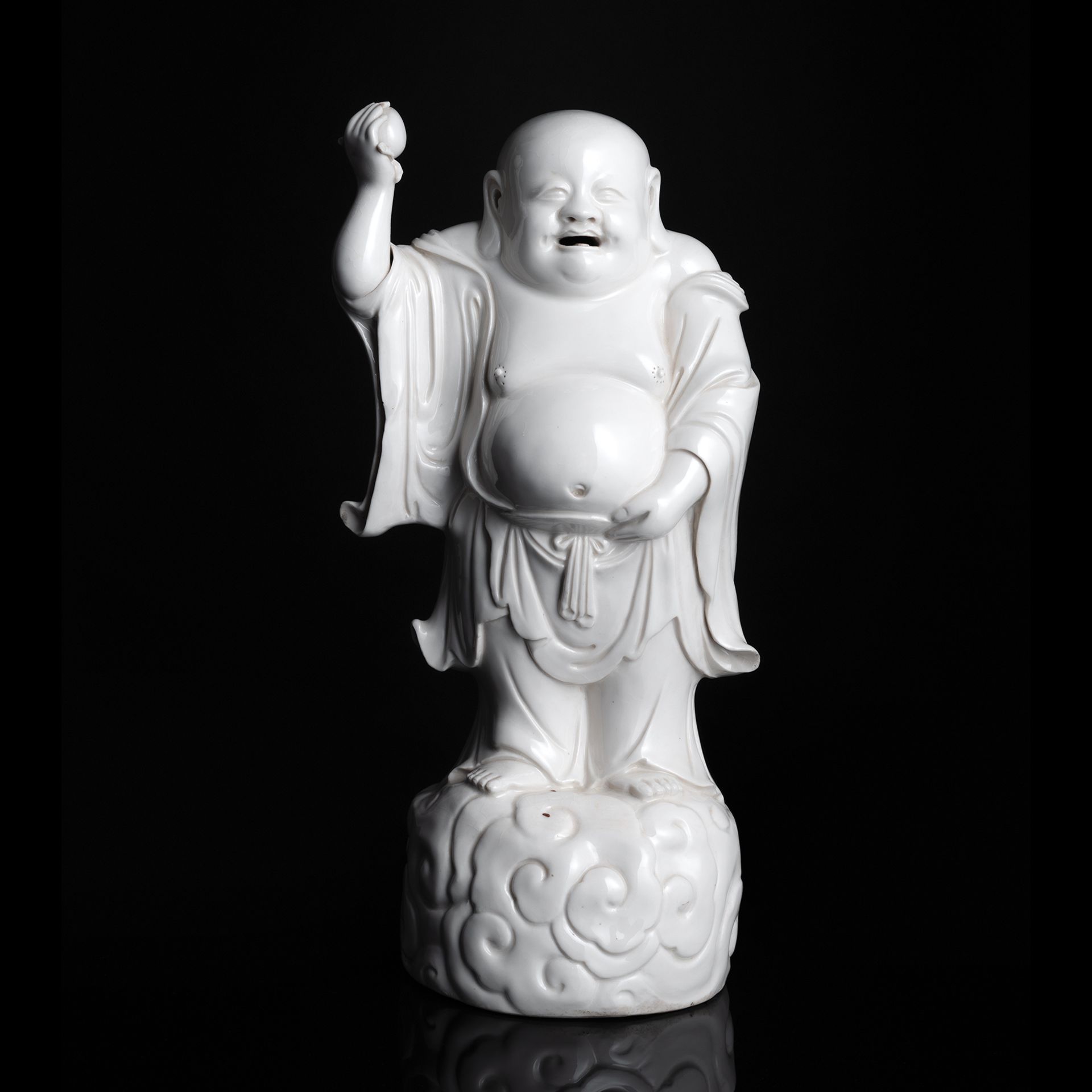 A RARE LIGHT CREAM-GLAZED MODEL OF STANDING BUDAI WITH PEACH