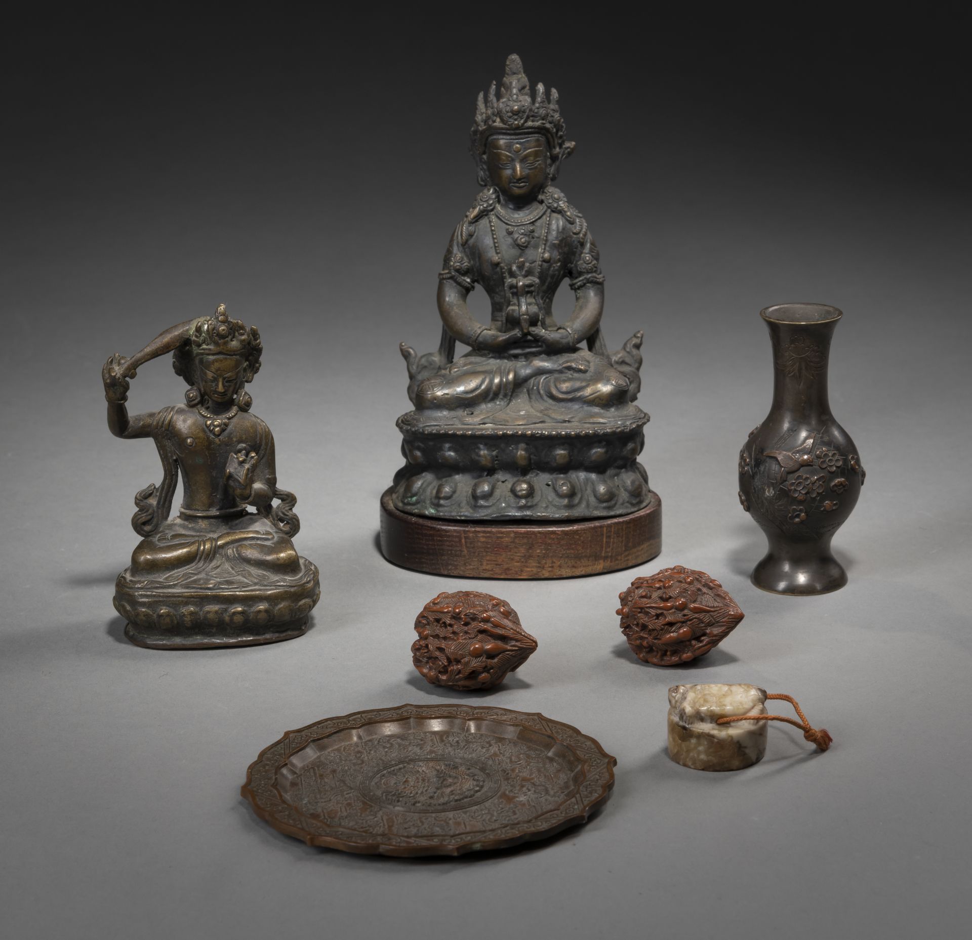 TWO BRONZE FIGURES OF AMITAYUS AND MANJUSHRI, A FLORIFORM BRONZE TRAY, TWO WALNUT CARVINGS, A SMALL