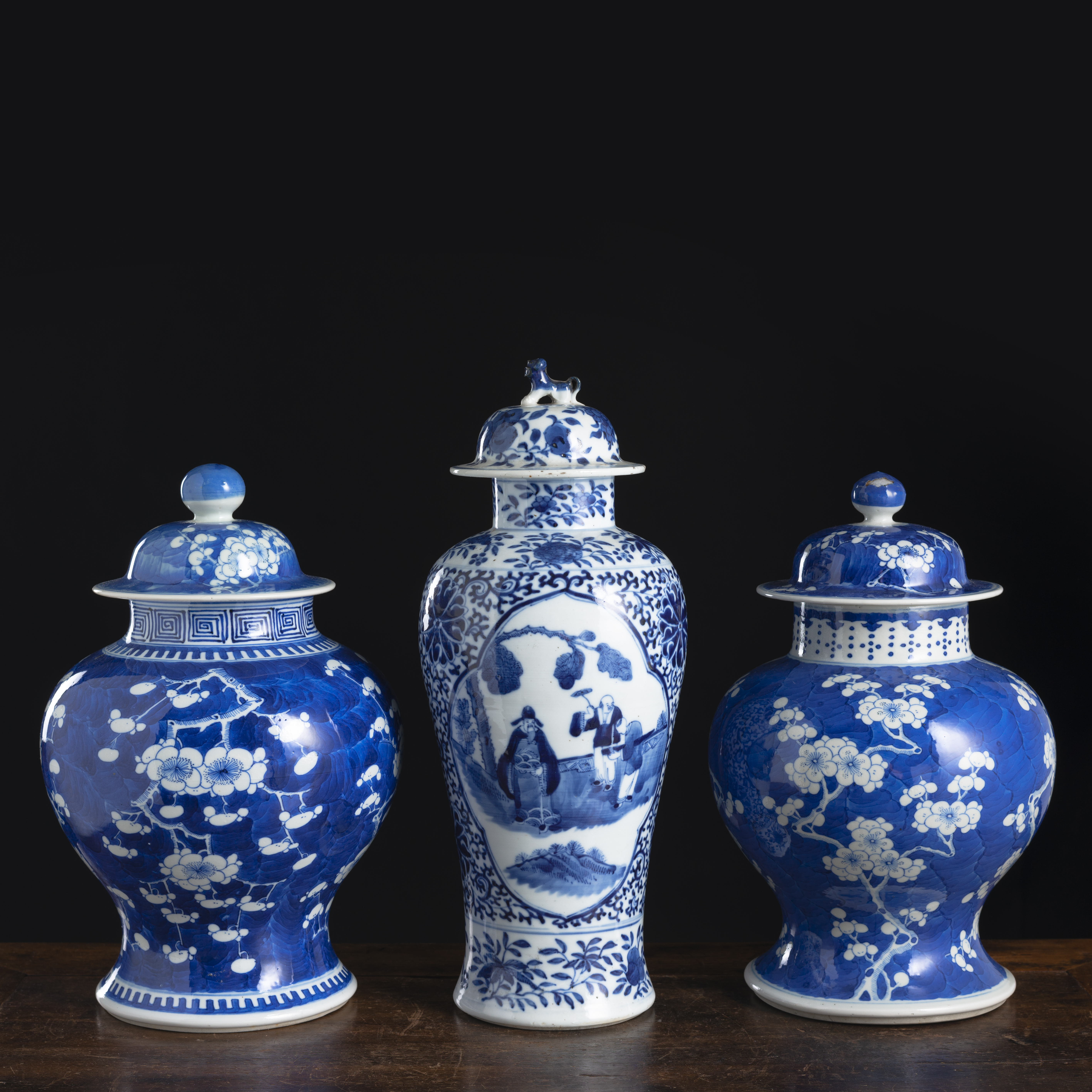 A PAIR OF BLUE AND WHITE PRUNUS PORCELAIN VASES AND COVERS AND AN ADDITIONAL VASE AND COVER