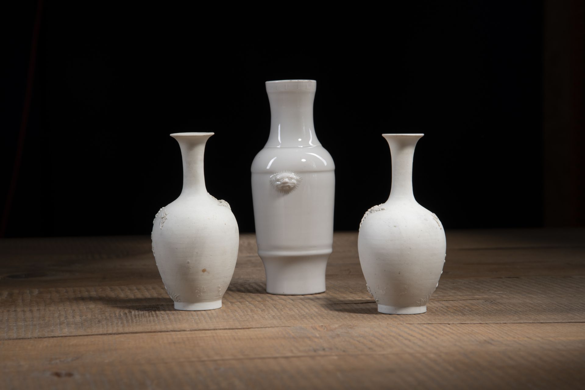 A PAIR OF BISCUIT PORCELAIN RELIEF CHRYSANTHEMUM VASES AND A DEHUA-WARE VASE - Image 2 of 4