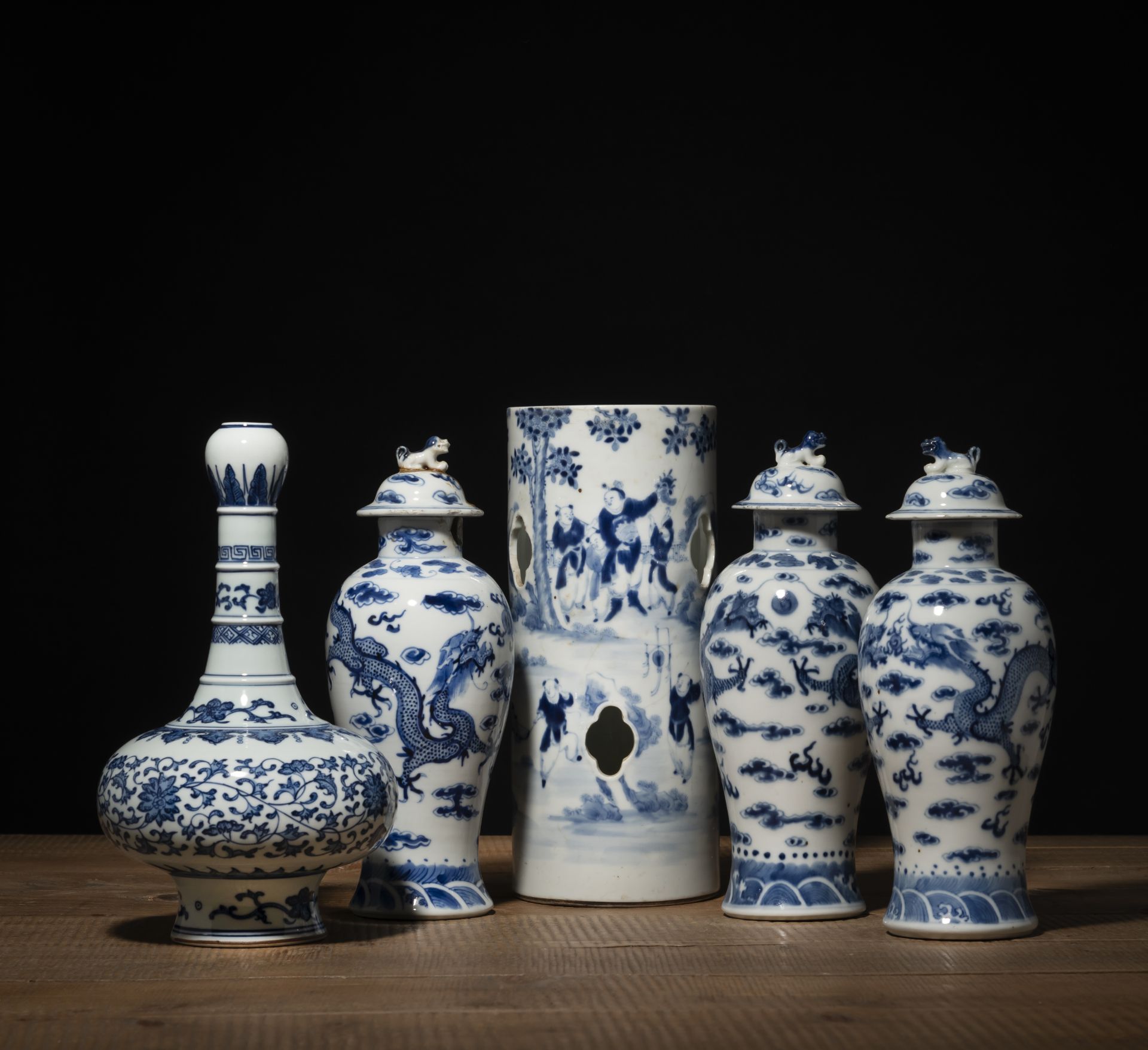 THREE BLUE AND WHITE PORCELAIN DRAGON VASES AND COVERS, A HAT STAND, AND A BOTTLE VASE