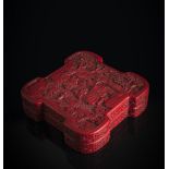 A WELL CARVED CINNABAR LACQUER BOX AND COVER OF UNUSUAL FORM