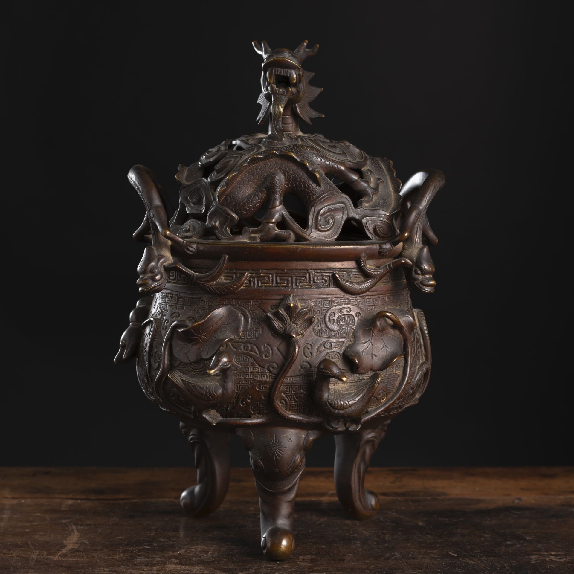 A GOOSE, HORSE, AND FISH RELIEF TRIPOD BRONZE CENSER AND OPENWORK DRAGON COVER