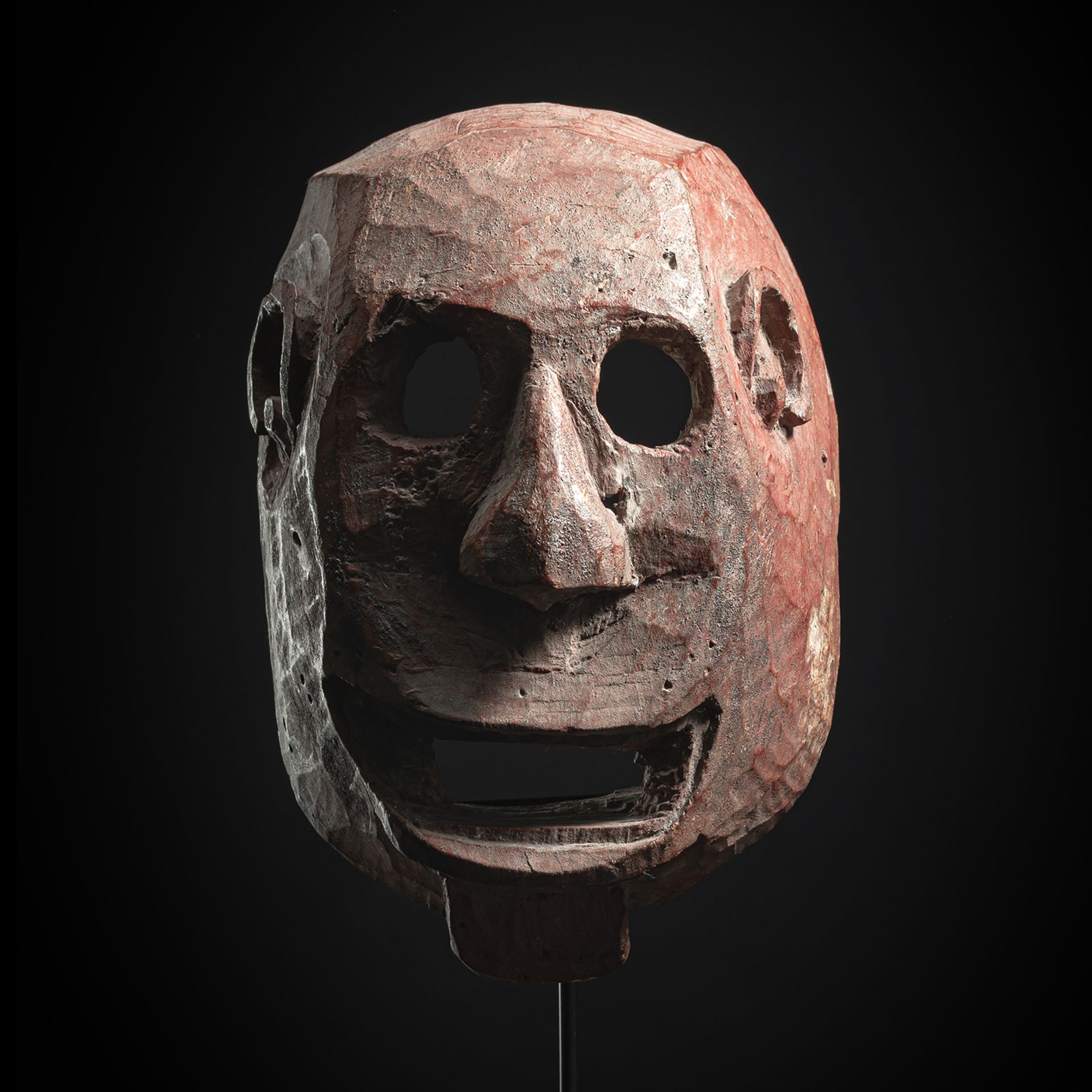 A LARGE RED-PAINTED SUKUMA WOOD MASK