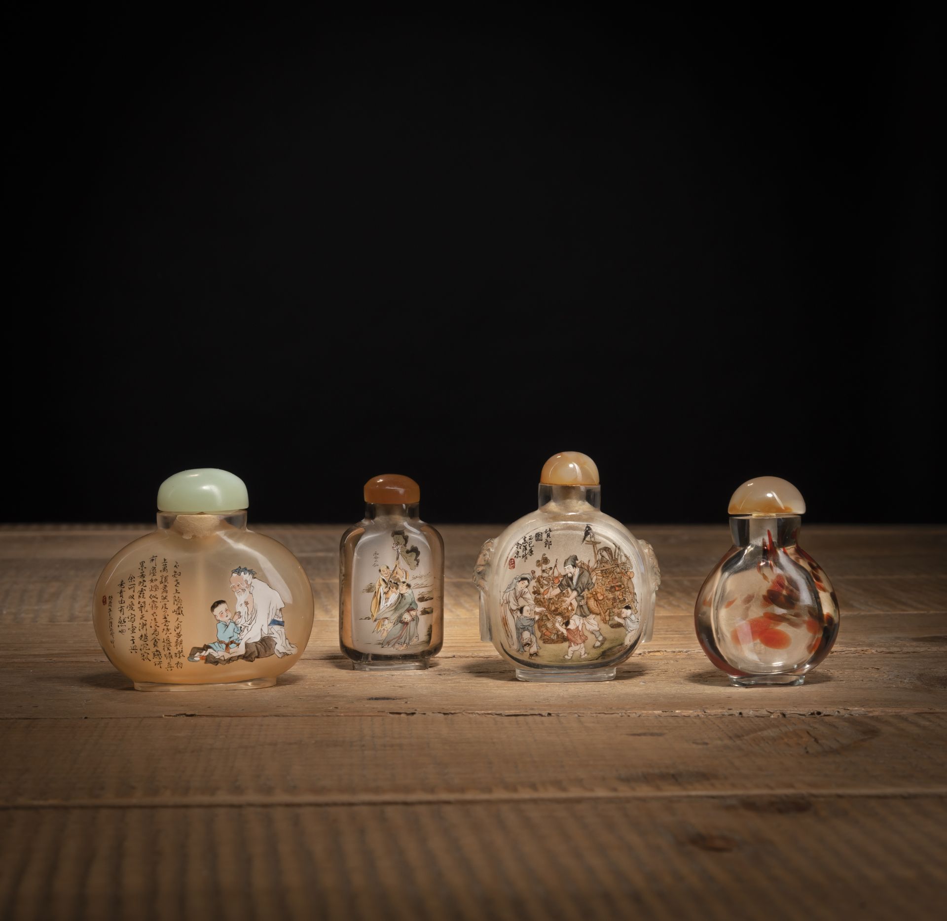 FOUR INSIDE-PAINTED GLASS AND CRASTAL SNUFF BOTTLES