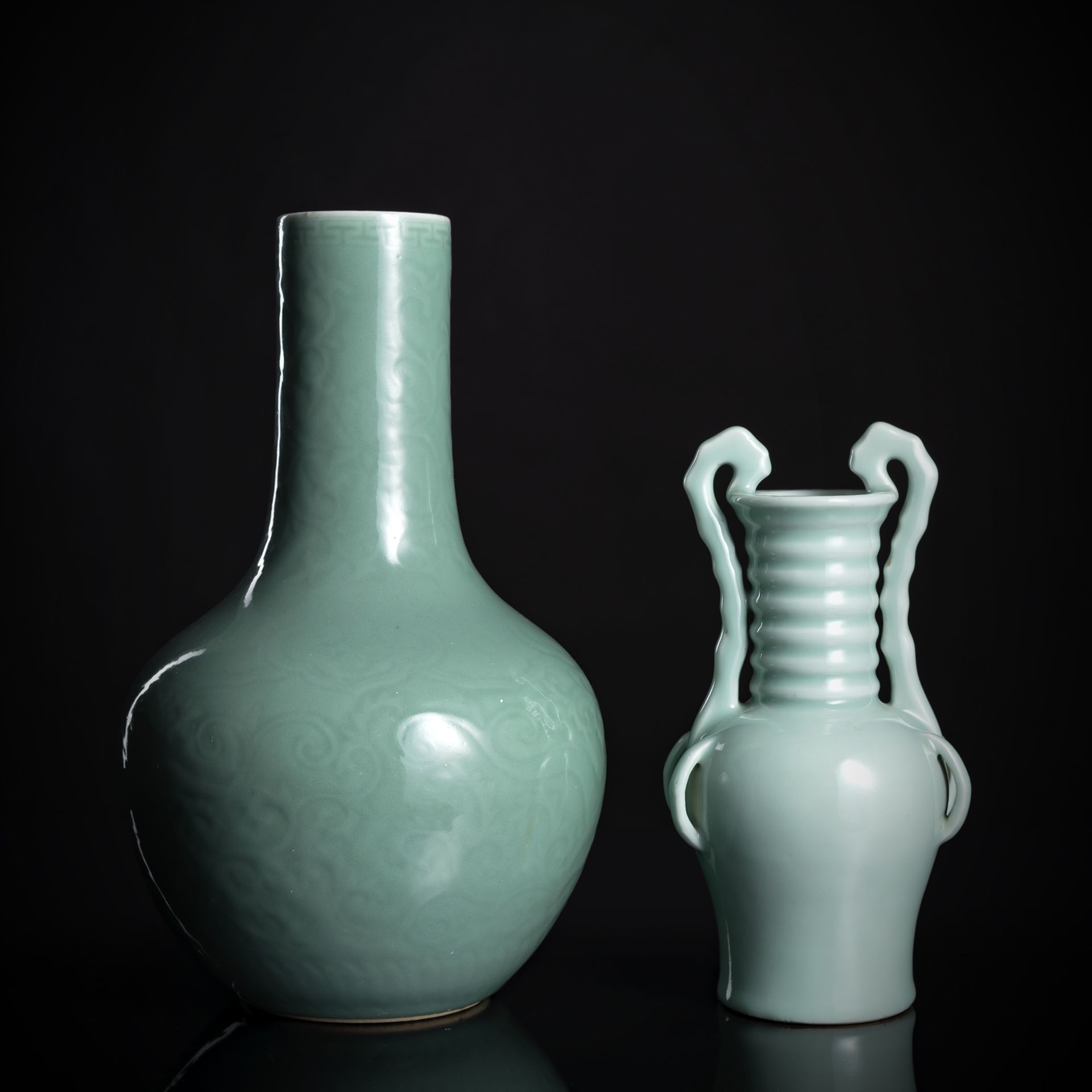 TWO CELADON-GLAZED VASES: A BOTTLE VASE WITH DRAGONS AND AN AMPHORA-SHAPED VASE IN ARCHAIC STYLE