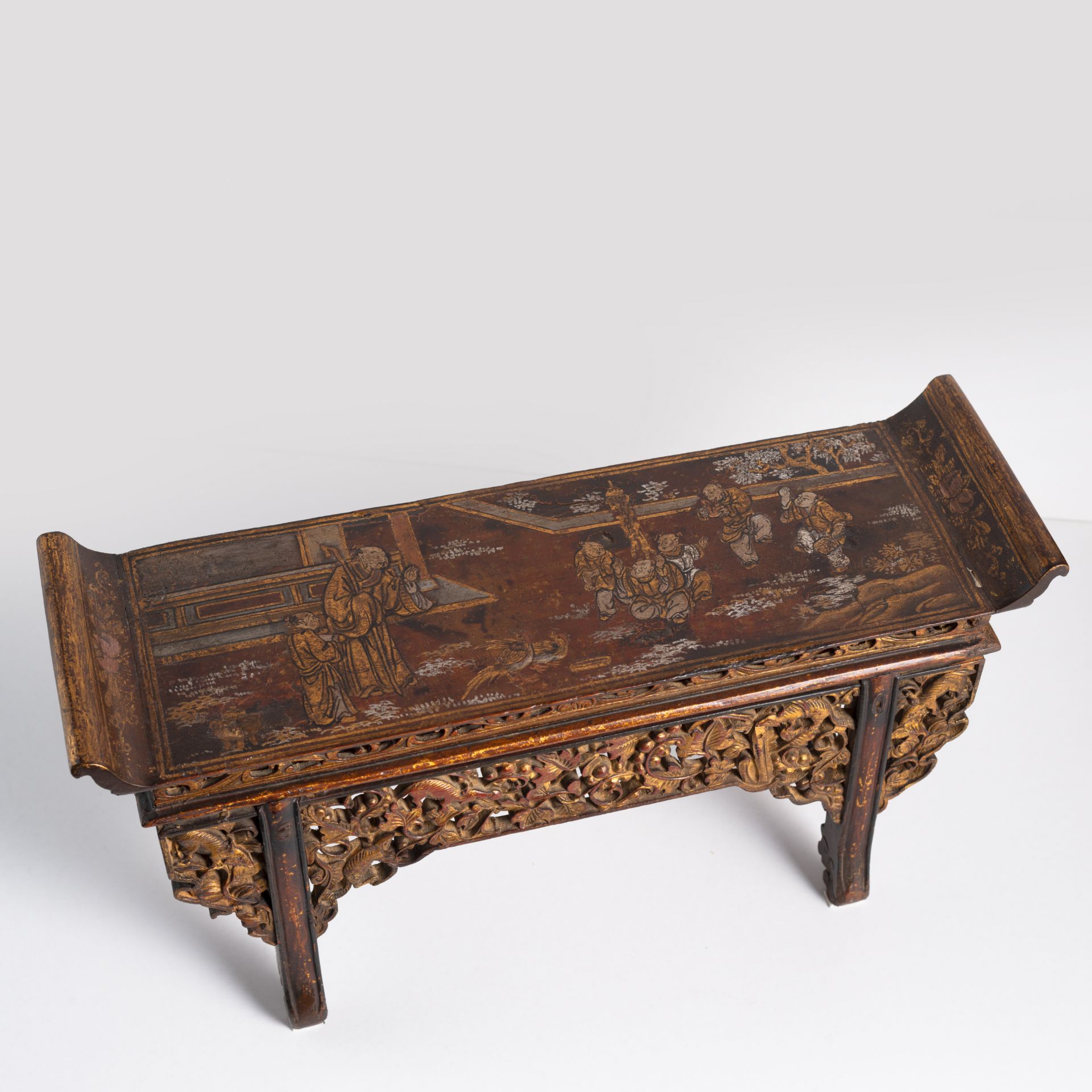 A MINIATURE WOOD ALTAR TABLE WITH FIGURAL LACQUERED DECORATION AND APRON WITH SQUIRREL AMIDST LEAV